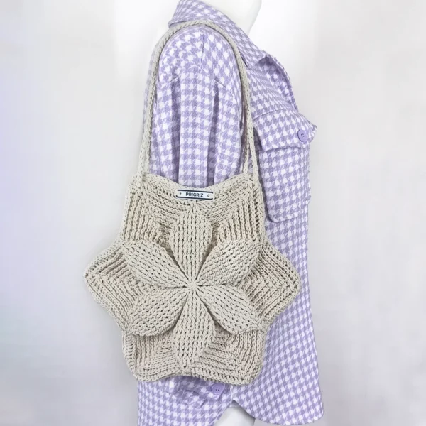 a mannequin wearing a purple and white checked shirt with a knitted bag PRIGRIZ